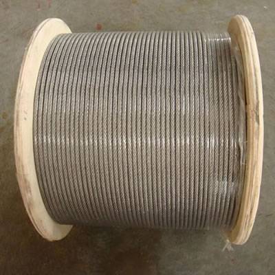 A roll of steel wire rope on the ground.